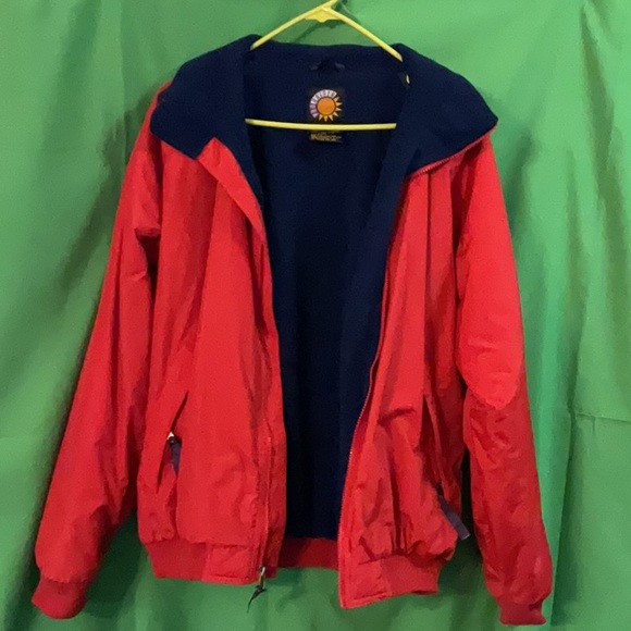Bright red windbreaker with navy blue fleece lining and insulated sleeves. - Picture 9 of 11